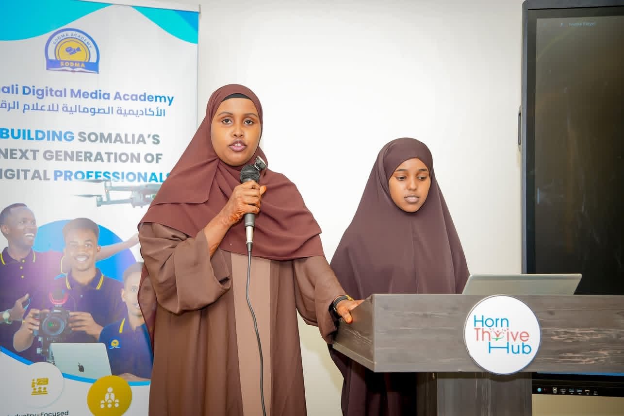 Two trainees presenting their project at the closing event
